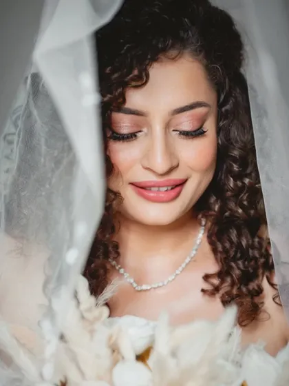 A dreamy shot through the veil. The soft focus and her gentle expression create a truly ethereal and romantic mood.
