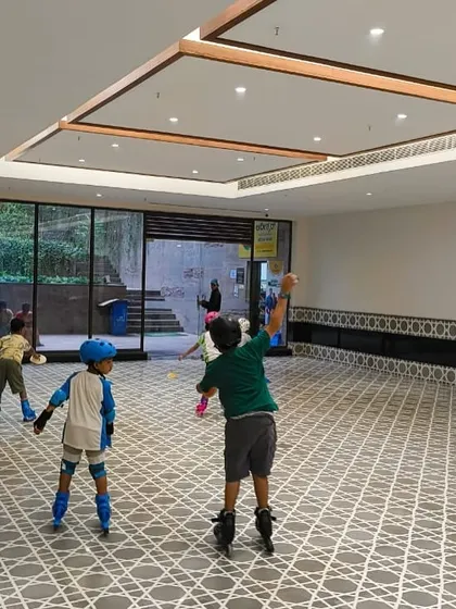 Kids practicing their skating skills in a spacious indoor hall, perfect for focused learning.