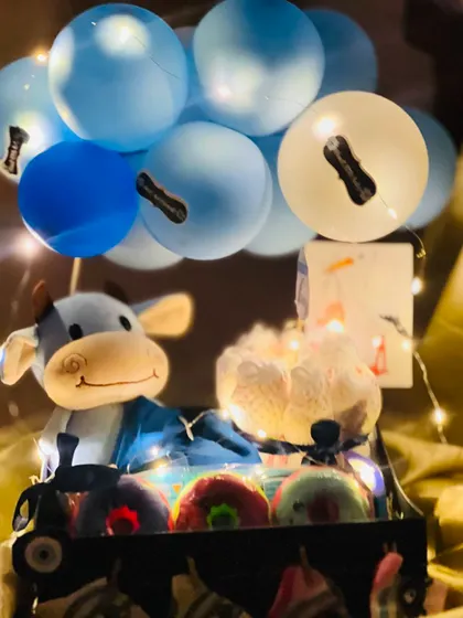 The same baby boy hamper illuminated with fairy lights. This adds a magical glow and makes the gift feel extra special, especially when given in the evening.