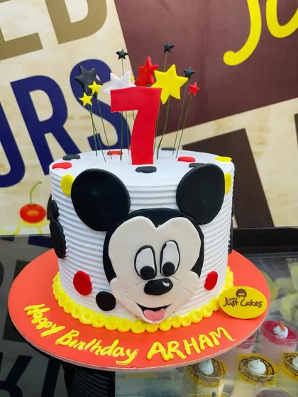 A 2kg Mickey Mouse cake with a big, friendly face and a star-studded top for a 7th birthday.