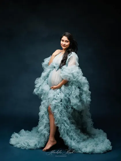 Wrapped in a cloud of ethereal blue ruffles, this gown creates a stunning, high-fashion silhouette that feels both gentle and powerful.