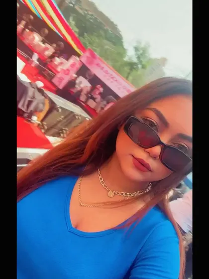 A selfie from the DJ booth with the colorful Holi stage in the background, ready to start my set.