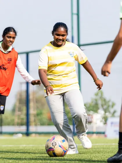 An NGO participant dribbles the ball with a smile. Our AFC Grassroots Day was a celebration of inclusivity and the joy of football.