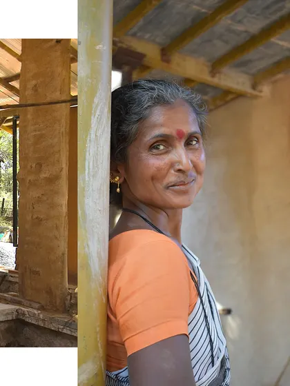 A portrait of one of the proud women masons on our team, with the natural walls she helped build in the background. Her smile reflects the confidence gained through her work.