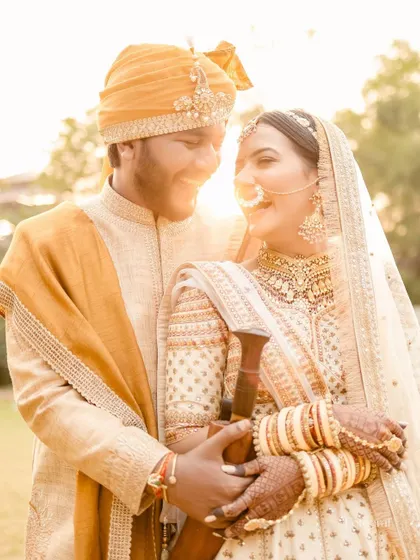 Draped in the richness of tradition and the warmth of the golden hour, this couple shares a look of pure love and happiness.