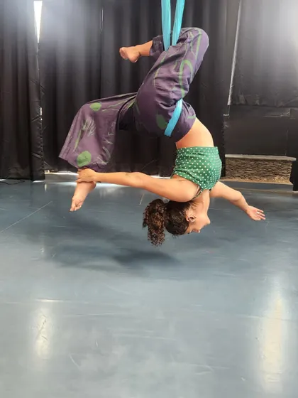 Happiness is finding a moment of flight. This pose in the aerial hammock is a beautiful expression of freedom and balance.