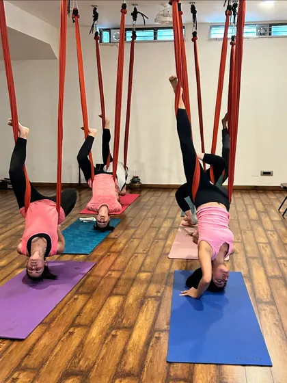 Another view of our aerial inversion class, highlighting the supportive and encouraging atmosphere of the studio.