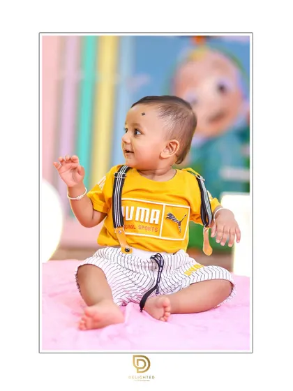 A candid smile during a first birthday shoot. These are the moments that truly show a child's personality.