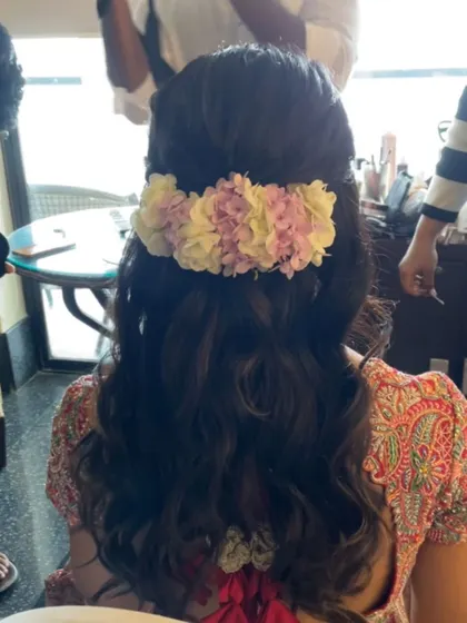 A romantic half-updo with soft waves, adorned with fresh hydrangeas. This hairstyle is perfect for a garden wedding, adding a touch of natural beauty.