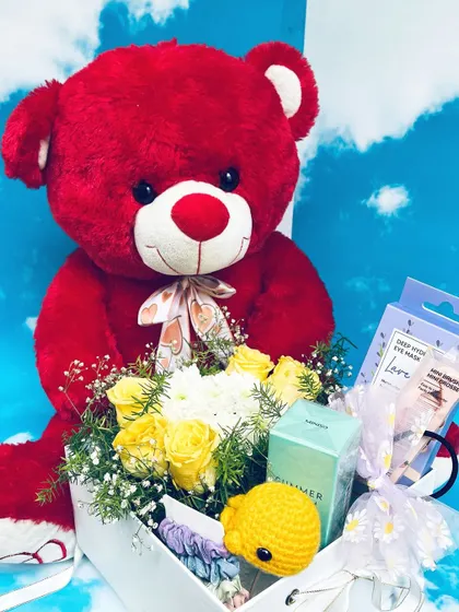 A grand gesture of love with this teddy hamper. A large red teddy bear is paired with a box of yellow roses, white chrysanthemums, and other pampering gifts.
