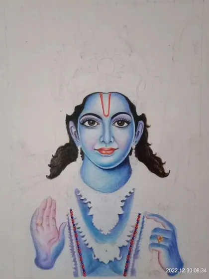 A work-in-progress shot of a color pencil portrait of Lord Rama. This image shows the early stages of applying color to the face and building up the layers.