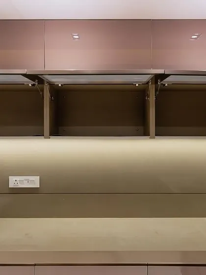 Bi-fold lift-up cabinets in the Malad project, demonstrating how we provide easy access to upper storage.