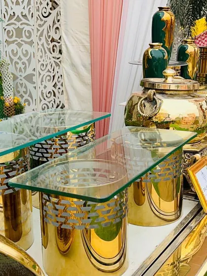 A beautiful outdoor buffet setup featuring polished brass chafing dishes and intricate decor. I use high-quality equipment and thoughtful design elements to ensure my catering stations enhance the overall aesthetic of the event.