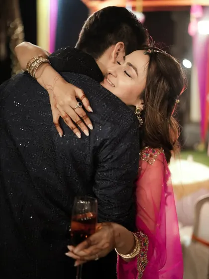 A heartfelt hug shared on the dance floor, a moment of quiet connection amidst the party.