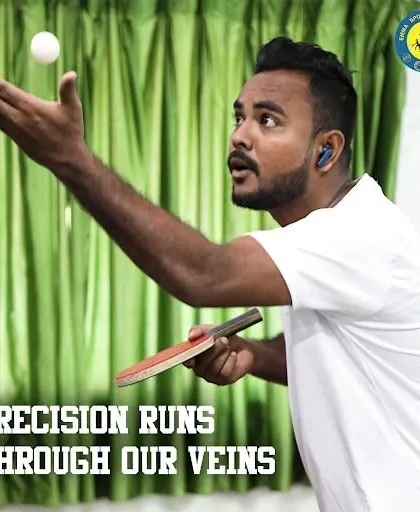 Precision runs through our veins. A coach demonstrates the focus required for a perfect table tennis serve.