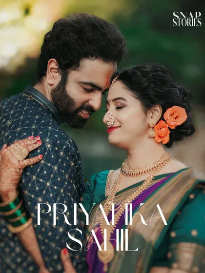 An intimate portrait of a couple, highlighting the bride's beautiful Paithani saree and traditional jewelry. We focus on capturing the rich textures and colors of Indian wedding attire.