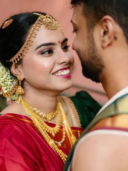 A close-up portrait capturing the bride's beautiful smile as she looks at her groom during their wedding day.