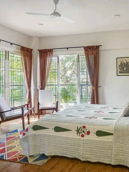 This bedroom is all about bringing the outdoors in. The large windows and simple decor let the natural light and green views be the star of the show.