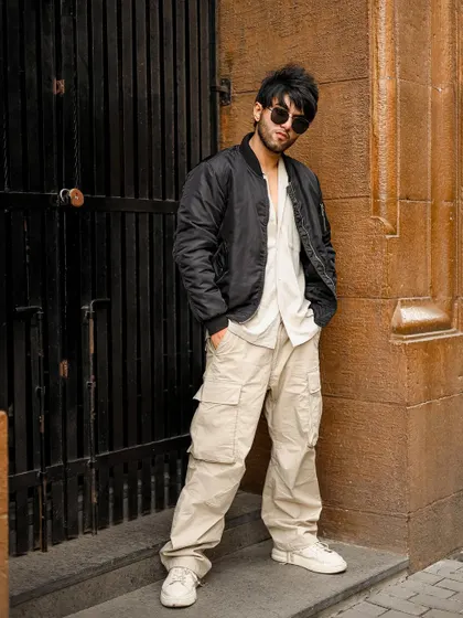 A full-length view of the men's street style outfit.