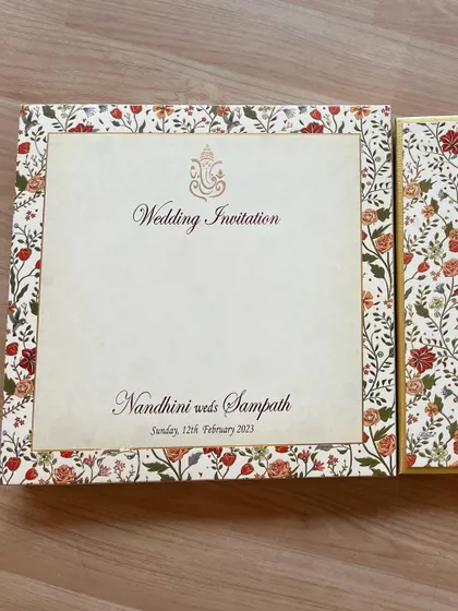 The cover of our classic floral invitation, featuring a Ganesha emblem for an auspicious start.