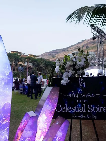 The entrance to the 'Celestial Soiree', featuring large, custom-made crystal props with a galaxy print. This immediately immerses guests in the out-of-this-world theme.