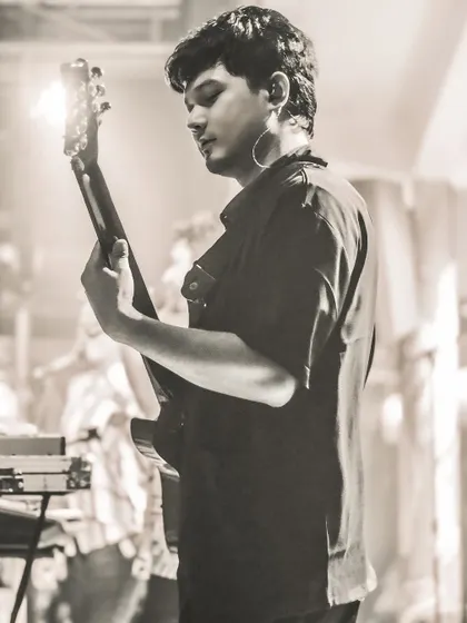 A shot of our talented keyboardist and guitarist, Sanjeet, focused during a live set. His musical skill adds incredible depth to our arrangements.