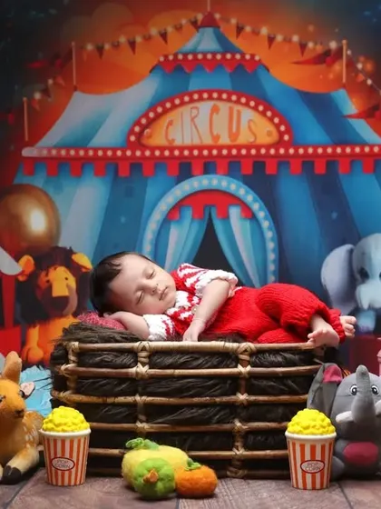 The greatest show on earth. A wider view of our circus theme, complete with popcorn props and a vibrant, fun-filled atmosphere for a memorable newborn shoot.