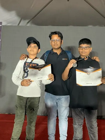 An instructor stands proudly with our senior team after they secured silver medals at the Mekathlon Robotics Competition. This success is a result of months of dedicated preparation and collaborative effort.