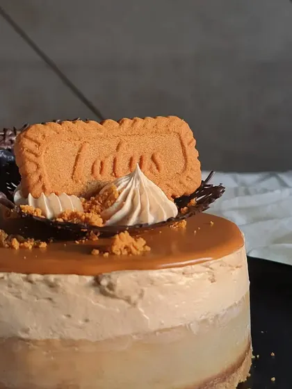 A close-up on the decoration. I use a delicate chocolate nest and piped cream to hold the Lotus biscuit in place, adding both flavor and a bit of height to the cake.