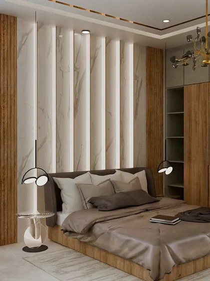 This bedroom showcases a beautiful blend of textures, with a marble and wood-paneled accent wall behind the bed. The elegant chandelier and modern bedside lamps add layers of light and sophistication.