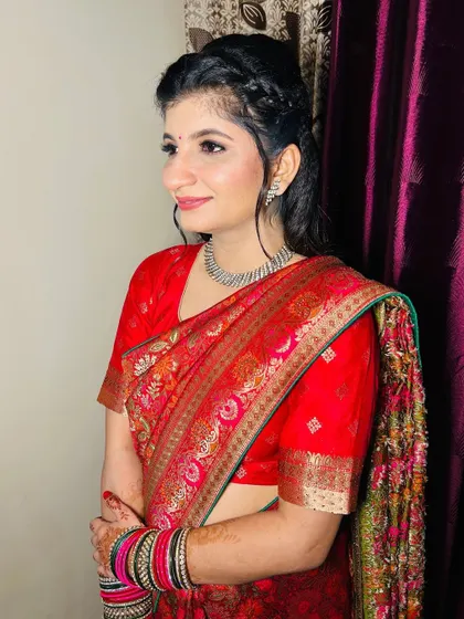 A side profile of the Roka bride, showing her elegant braided hairstyle and glowing makeup.