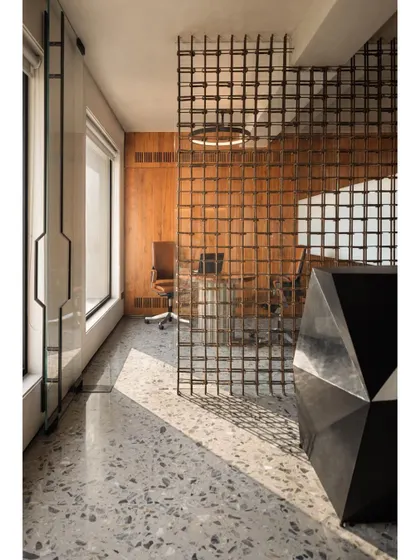 For a construction firm's office, we used reinforced steel bars, a common building material, to create a delicate and visually permeable screen that separates the reception from the conference area.