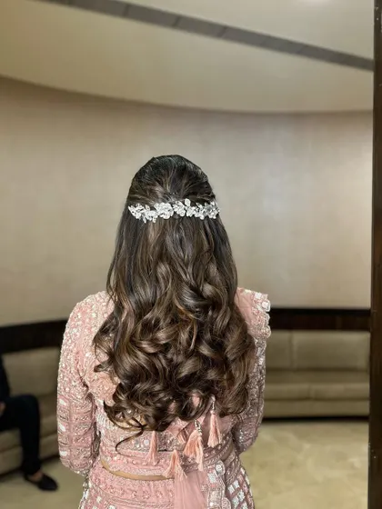 The back view of the reception hairstyle. The sparkling accessory adds the perfect amount of glam for an evening event.