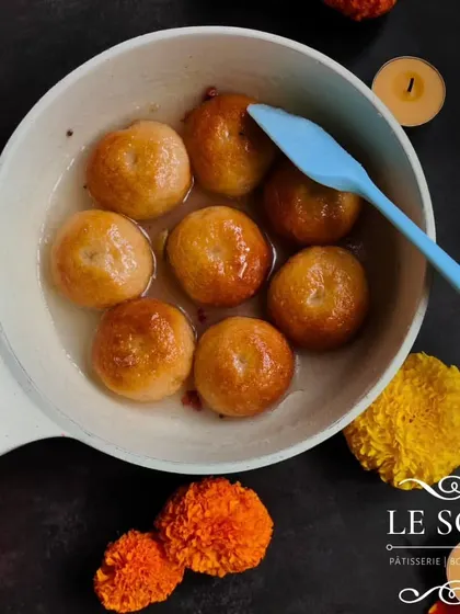 Here you can see my Baadusha-style doughnuts soaking in a light sugar syrup. This process ensures they are moist and flavorful, just like the classic mithai.