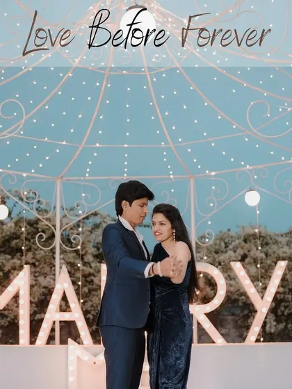 A romantic dance under a canopy of fairy lights, with the "Marry Me" sign in the background, creating a dreamy and unforgettable pre-wedding moment.