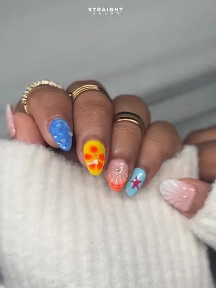 Another view of the vibrant, beachy nail art. Each nail tells a part of the story, from the textured water drops to the colorful starfish, making for a truly unique and eye-catching set.
