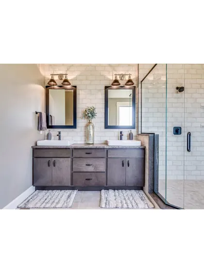 A classic bathroom design with a double vanity, perfect for a master suite. The white subway tiles in the shower and the dark wood of the vanity create a timeless and functional space.
