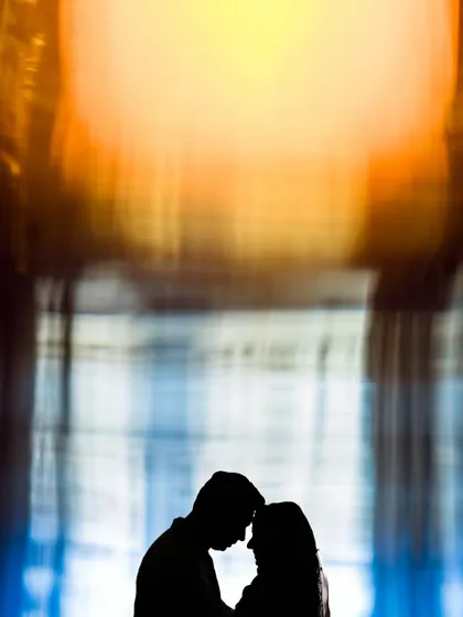 An abstract silhouette against a colorful, blurry background. This is an example of my experimental and artistic approach to couple portraits.
