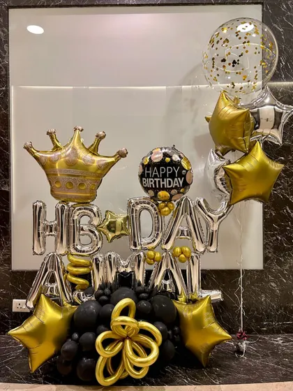 This is for when you want to make a big, bold statement with balloons. I created this custom 'Happy Birthday Amma' balloon bouquet with a crown, stars, and a black and gold theme for a truly royal celebration.