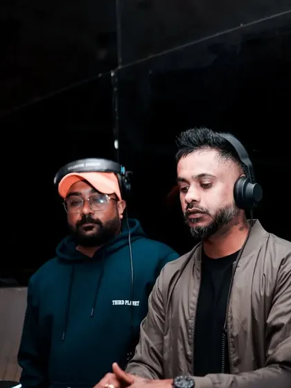 In the zone with another DJ. Collaborating in real-time, we feed off each other's energy to create a unique live mix that you can't get from a solo set.