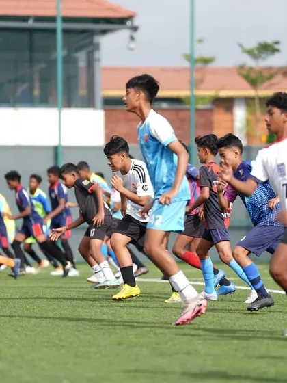 Young talents sprinting during a fitness test at our final trials. We assess speed, agility, and endurance to find the best players.