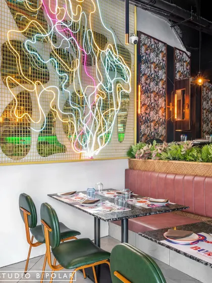 This custom neon art piece is the dramatic focal point of Burosu. Its abstract, flowing lines in multiple colors create a sense of movement and energy, perfectly capturing the essence of modern Asian street culture.