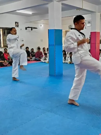 Two students demonstrate a kicking form.