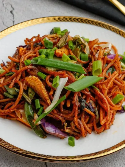 A close-up of our perfectly tossed Teppanyaki noodles. You can see the variety of fresh vegetables like baby corn, cabbage, and spring onions that make this dish so vibrant and delicious.