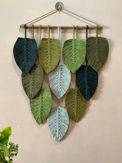 Another view of the green leaf wall hanging, showing how it looks in a home setting. It's a wonderful way to add a touch of nature-inspired art to your decor.