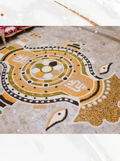 A traditional rangoli made from food grains for an auspicious Siddh Chakra Pujan. We have been hosting events for three decades, focusing on these delicate, meaningful details.
