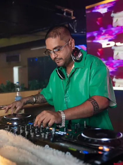 Mixing live at No Limmits. The green shirt and the focused look mean I'm deep into a set, making sure every transition is seamless for the Bollywood night.