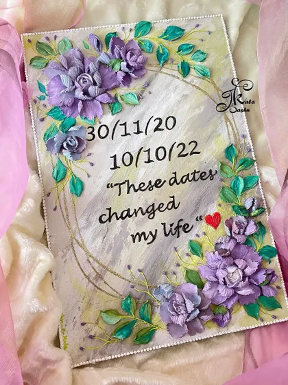 A custom quote board with important dates, framed by beautiful amethyst-colored hybrid flowers. A perfect way to commemorate special moments.