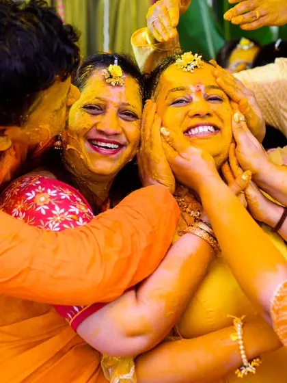 A full on family hug, with everyone covered in haldi. These moments of collective, messy joy are the heart and soul of a fun Haldi ceremony.