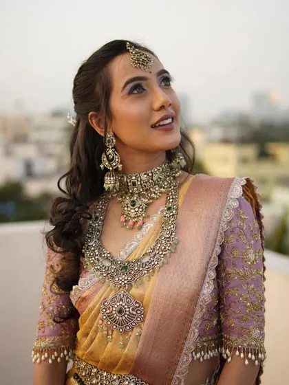An outdoor shot that captures the natural beauty of the model and the intricate details of the jewellery.
